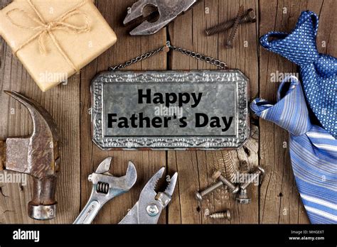 Happy Fathers Day Message On Metal Sign With Frame Of Tools Ts And Ties On A Wooden