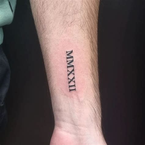 Forearm male roman numerals tattoo | Orangetattooshop.com