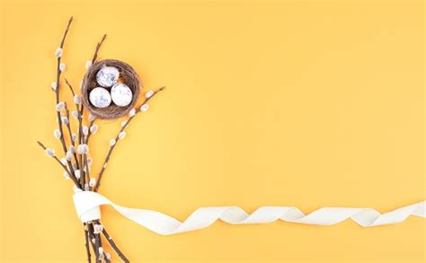 Premium Photo Easter Holiday Background Wicker Nest With Small Eggs Branches Of Pussy Willow