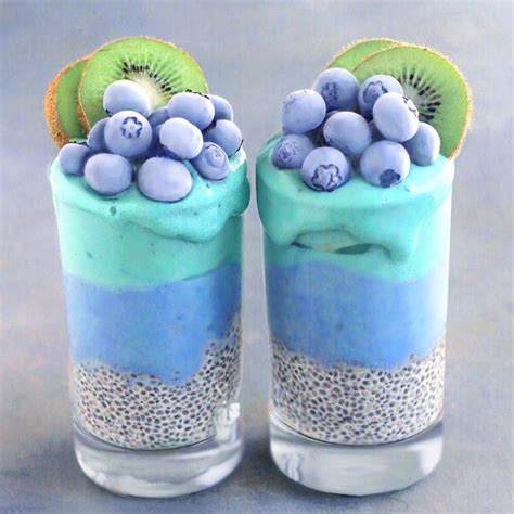 Two Glasses Filled With Blue And Green Desserts