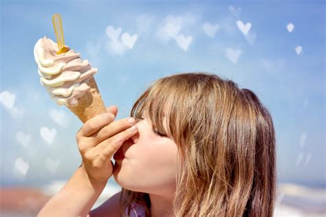 Portrait Of A Young Girl Enjoying A Big Ice Cream Cone Stock Photo