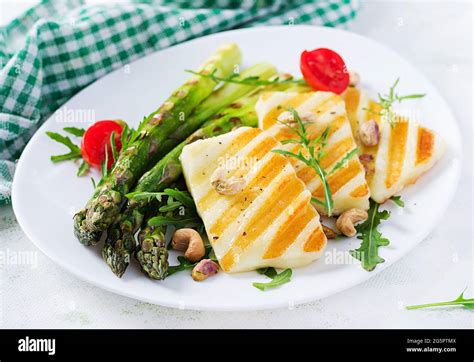 Grilled Halloumi Cheese Salad With Tomatoes And Asparagus On Plate On