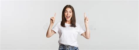 Attractive Smiling Brunette Girl Pointing Fingers Up Showing Logo Stock Image Image Of Beauty