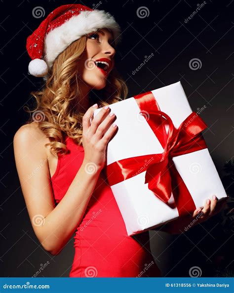 Blonde Santa In A Red Dress Holding Christmas Present Stock Photo Image Of Ornaments Holidays