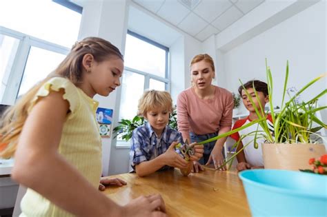 Premium Photo Boy Using Pliers Blonde Haired Boy Using Pliers Cutting Edges Of Plant Standing