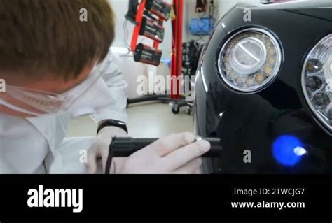 A Professional Male Boy Master Of Ceramics Of A Car Puts Ceramics On