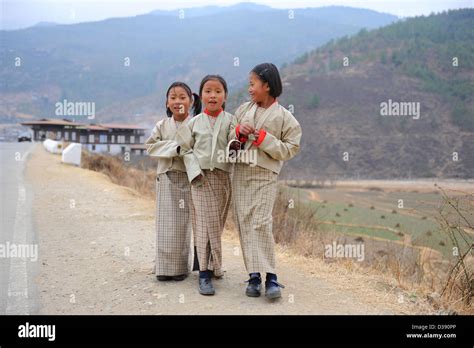 Three Young School Girls In Bhutan National Dress Which Is Also Their