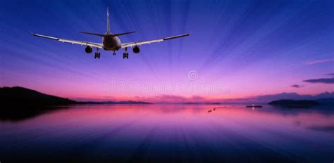 Airplane Flying In The Sky Tropical Sea At Sunset Time Stock Photo