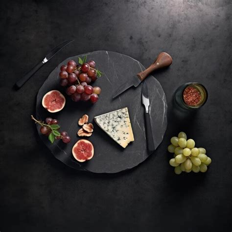 Premium AI Image | Cheese platter with grapes figs and honey on dark background