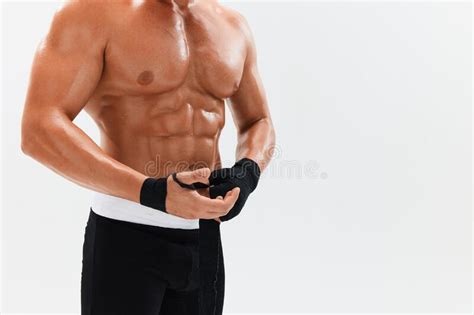 Man Athletic Bodybuilder Poses In Boxing Gloves With Nude Torso Abs In Full Length Background