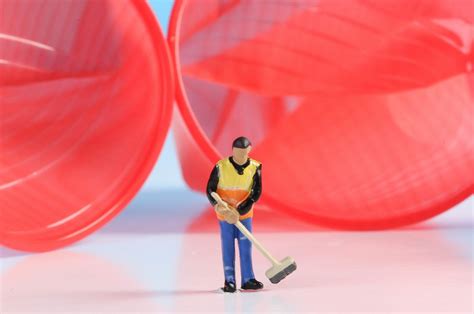 Miniature cleaning worker with empty plastic bottle - Creative Commons ...
