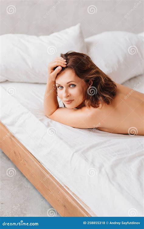 Naked Brunette Woman Lying In Bed Women X S Health And Attractiveness Stock Photo Image Of