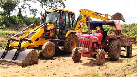 Jcb Dx Backhoe Machine Loading Mud In Mahindra Di And Mahindra