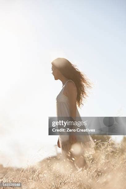 Women Walking Through Tall Grass Photos And Premium High Res Pictures