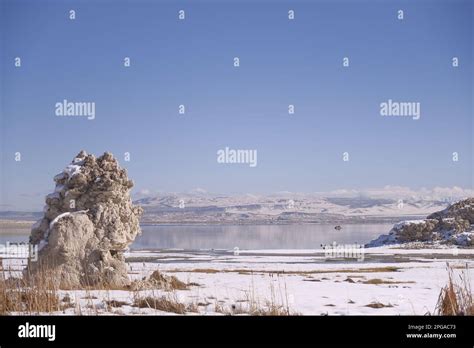 A Stunning Winter Landscape Featuring A Lake Surrounded By Snow Capped