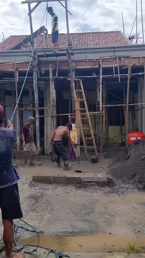 construction workers busy   building site  scaffolding stock