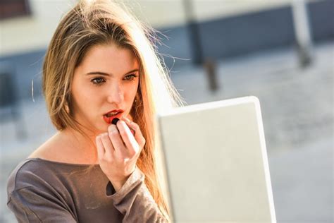 Free Photo Close Up Of Blonde Woman Painting Her Lips With A Lipstick