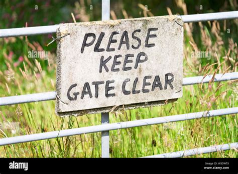 Please Keep Gate Clear Sign In Metal Gate Fence Stock Photo Alamy