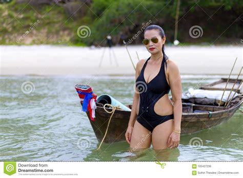Bikini Y Barco Del Negro Del Sex Symbol De La Forma De La Mujer En La Playa Foto De Archivo
