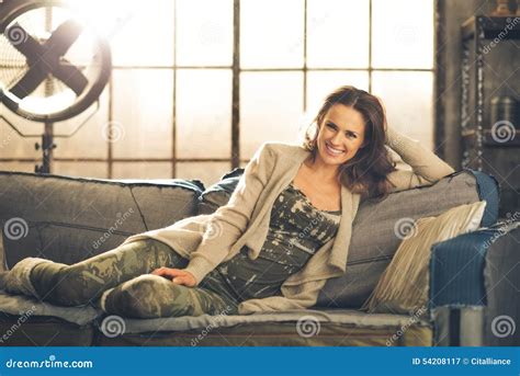 A Brunette Woman Is Smiling Relaxing On A Sofa Stock Image Image Of Apartment Livingroom