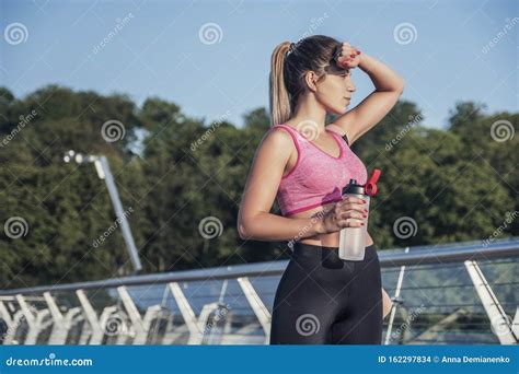 Slim Fit Caucasian Brunette Woman Outdoor Exercising In Sport Outfit Summer Morning Stock Photo