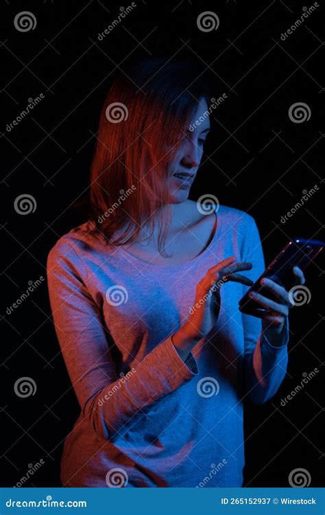 Caucasian Woman Using Her Mobile Phone While Smiling Stock Image