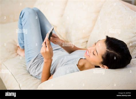 Smiling Brunette Using Smartphone Stock Photo Alamy