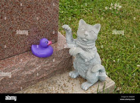 Stone Cat With Rubber Duck On Tombstone Stock Photo Alamy