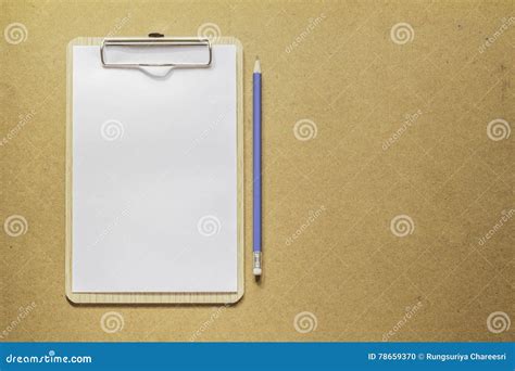 Clipboard With White Paper And Pencil On Wooden Table Stock Photo