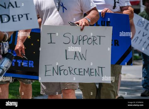 A Man Holds A Placard Saying I Support Law Enforcement During A Pro