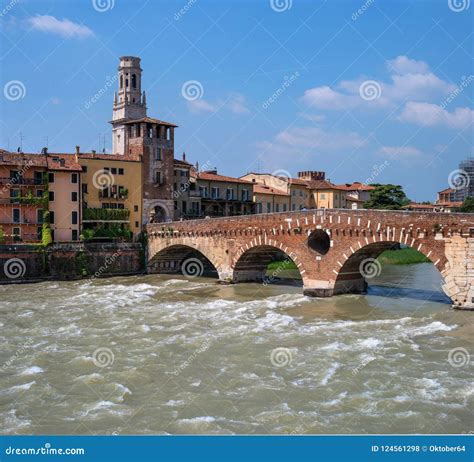 Ancient Roman Bridge Ponte Pietra and the River Adige in Cloudy Summer