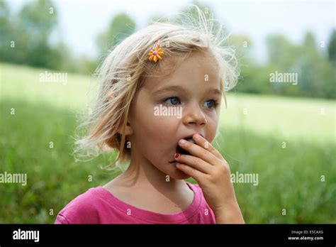Portrait De Jeune Fille Blonde Enfant Manger Une Prune On Meadow Photo Stock Alamy