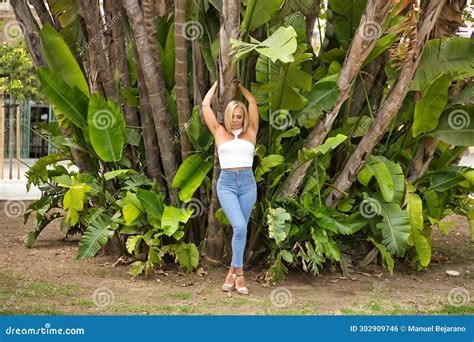 Mature Woman Beautiful Blonde With White Top And Jeans Eyes Closed Connected To Nature