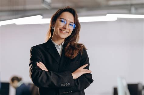 Premium Photo Ambitious Businesswoman In Glasses Posing With Folded