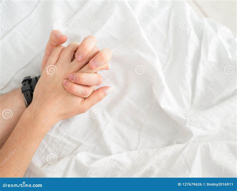 Close Up Of Passionate Couple Hold Hands During Making Intense Love In Bedroom Lovers Enjoy Hot