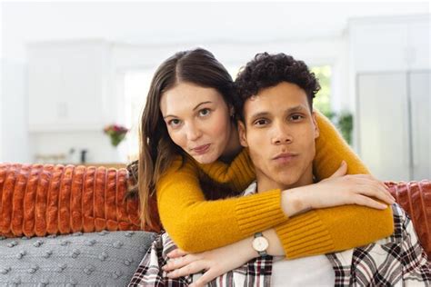 Premium Photo Portrait Of Happy Diverse Couple Embracing On Couch At