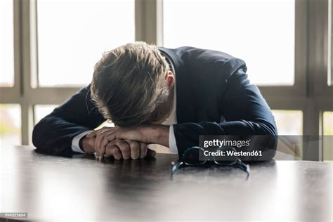 Mature Businessman Resting His Head On The Table High-Res Stock Photo ...