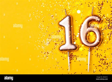 gold candles   form  number sixteen  yellow background