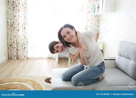 Beautiful Brunette Mom And Son Hugging On Couch Stock Image Image Of Mood Kiss 122789801