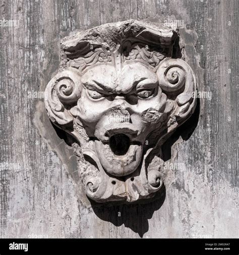 Grotesque Face On A Water Fountain In The Gardens Of St Georges Castle