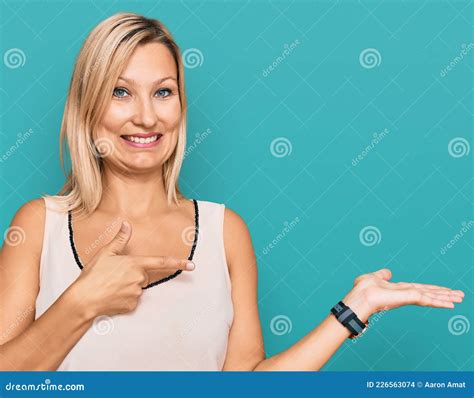 Middle Age Caucasian Woman Wearing Casual Clothes Amazed And Smiling To