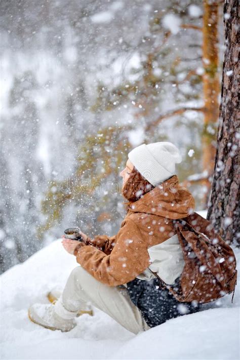 Redhead Woman Sit On Snow On Top Of Mountains Relaxing Drinking Hot Tea Snowfall Stock Image