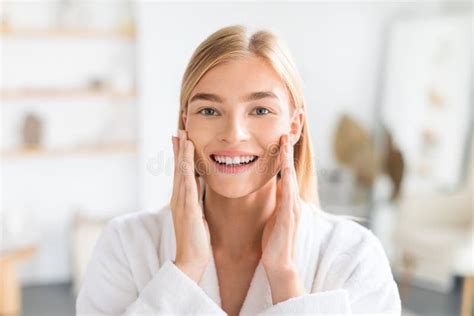 Portrait Of Blonde Lady Touches Cheeks Enjoys Morning Skincare Indoor Stock Image Image Of