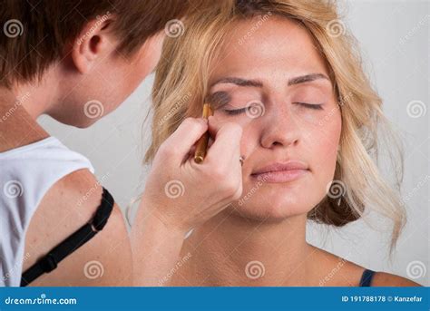 Professional Make Up Artist Doing Makeup To A Blonde Behind The Scenes