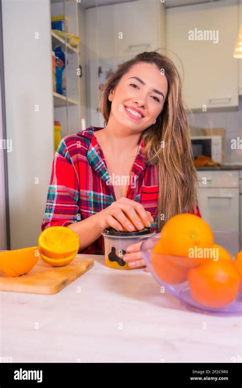 A Blonde Spanish Woman Making Orange Juice For Breakfast In Her Kitchen Stock Photo Alamy