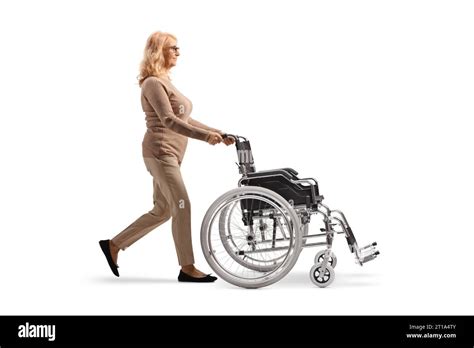 Full Length Profile Shot Of A Mature Woman Walking And Pushing An Empty