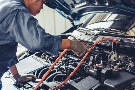 Mecânico Eletricista De Automóveis - mecânico de automóveis segurando a eletricidade da bateria através dos ...
