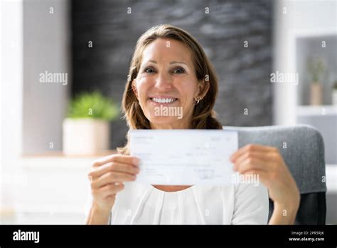 Businesswoman Holding Cheque Stock Photo Alamy