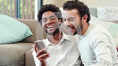 Gay Couple Relaxing On The Couch Taking Selfie Stock Footage Video Of Adult Hair