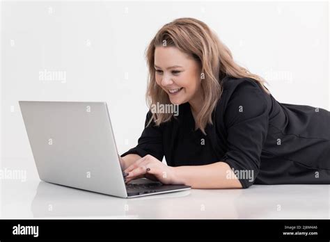 Smiling And Laughing Blonde Woman Lying On Floor Using Laptop Online Education E Learning